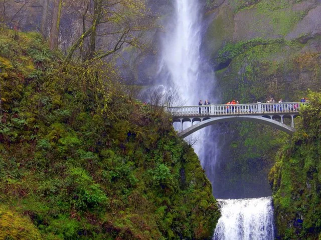 Visitors viewing Multnomah Falls from the iconic Benson Footbridge